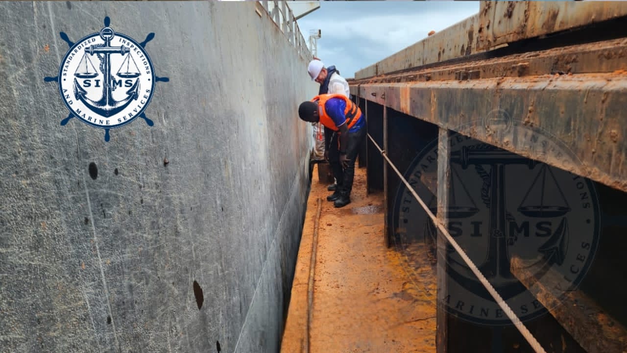 Surveyors reading draft marks and recording readings at the bow