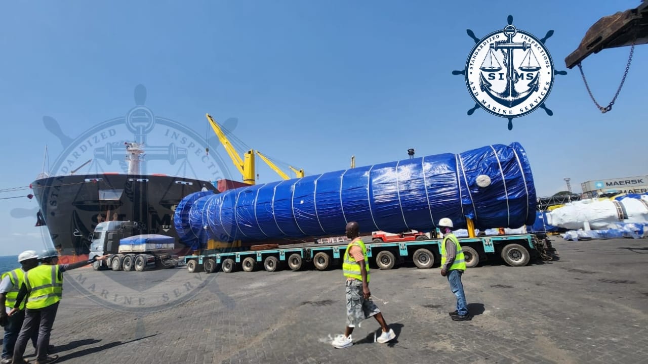 Out-of-gauge pressure vessel on a multi-axle trailer alongside the vessel