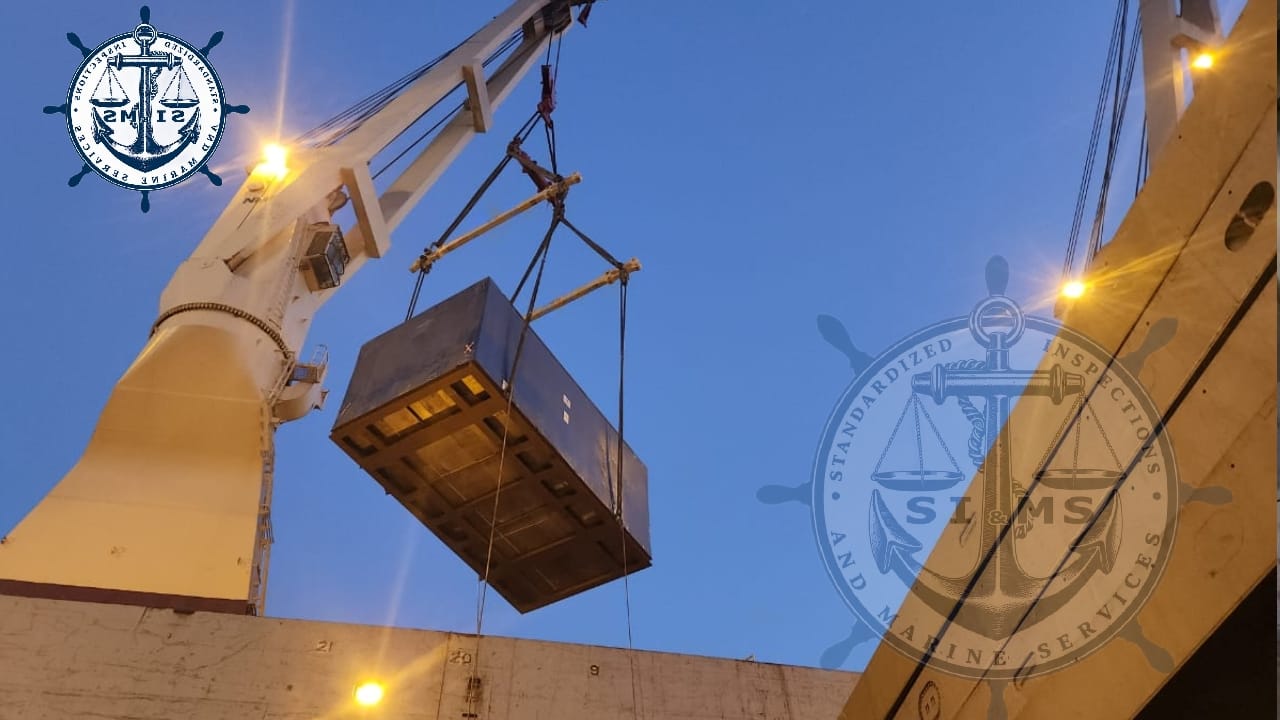 Crated cargo lowered into the hold at last light